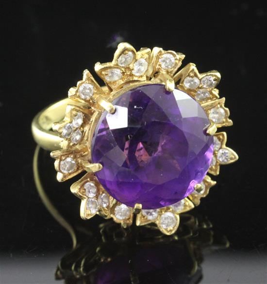 An 18ct gold, amethyst and diamond cluster ring, size M.